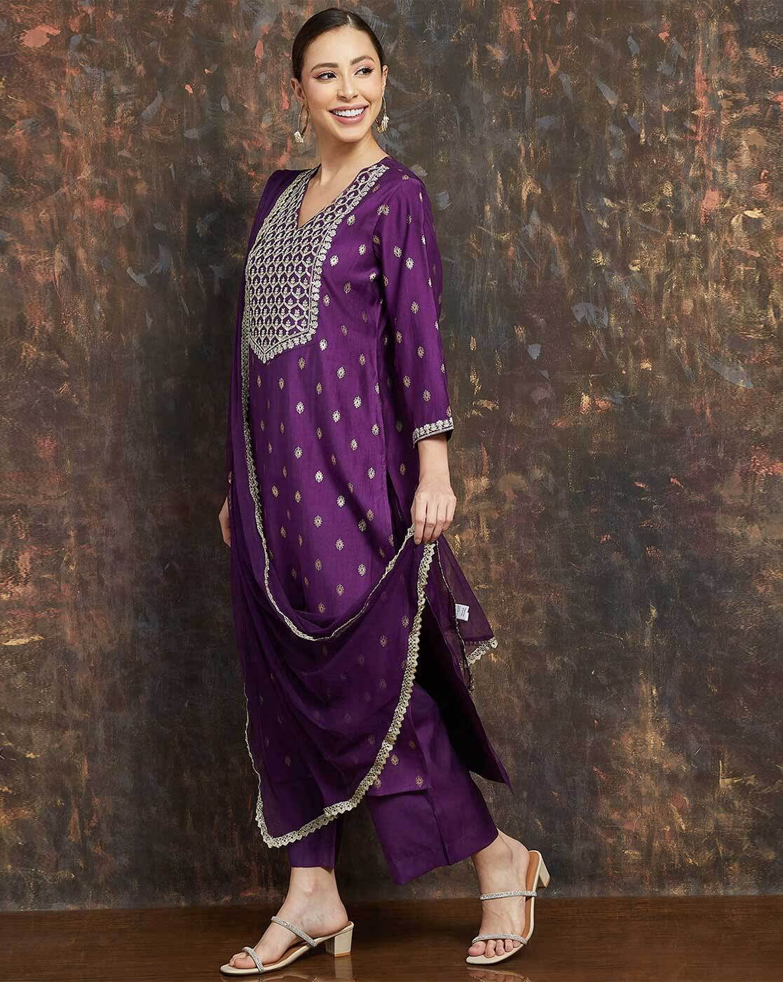 Women's embroidered kurta suit set in purple with intricate detailing and elegant design for festive occasions