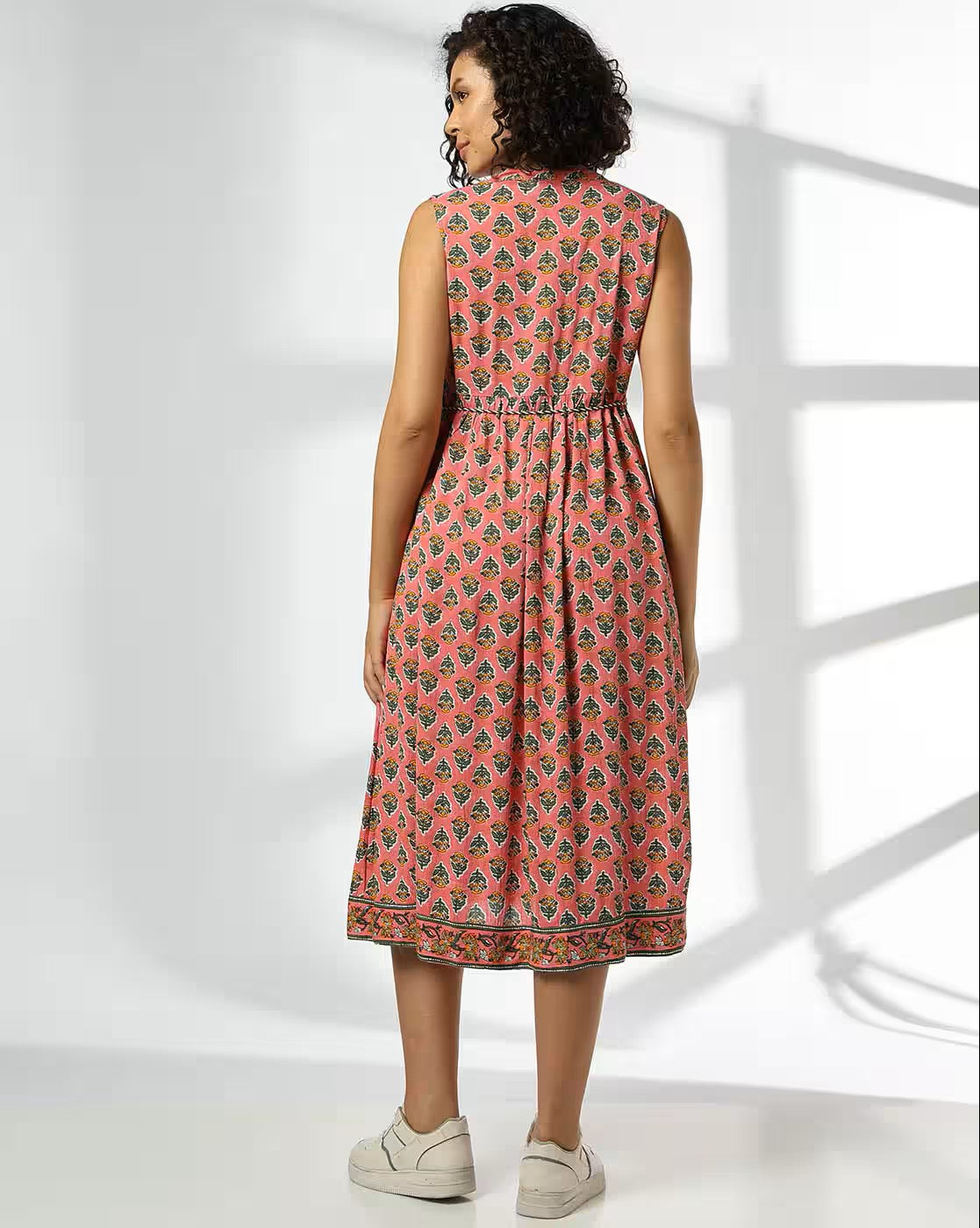 Aromie women's floral fit and flare dress in coral with sleeveless design and cinched waist shown from back