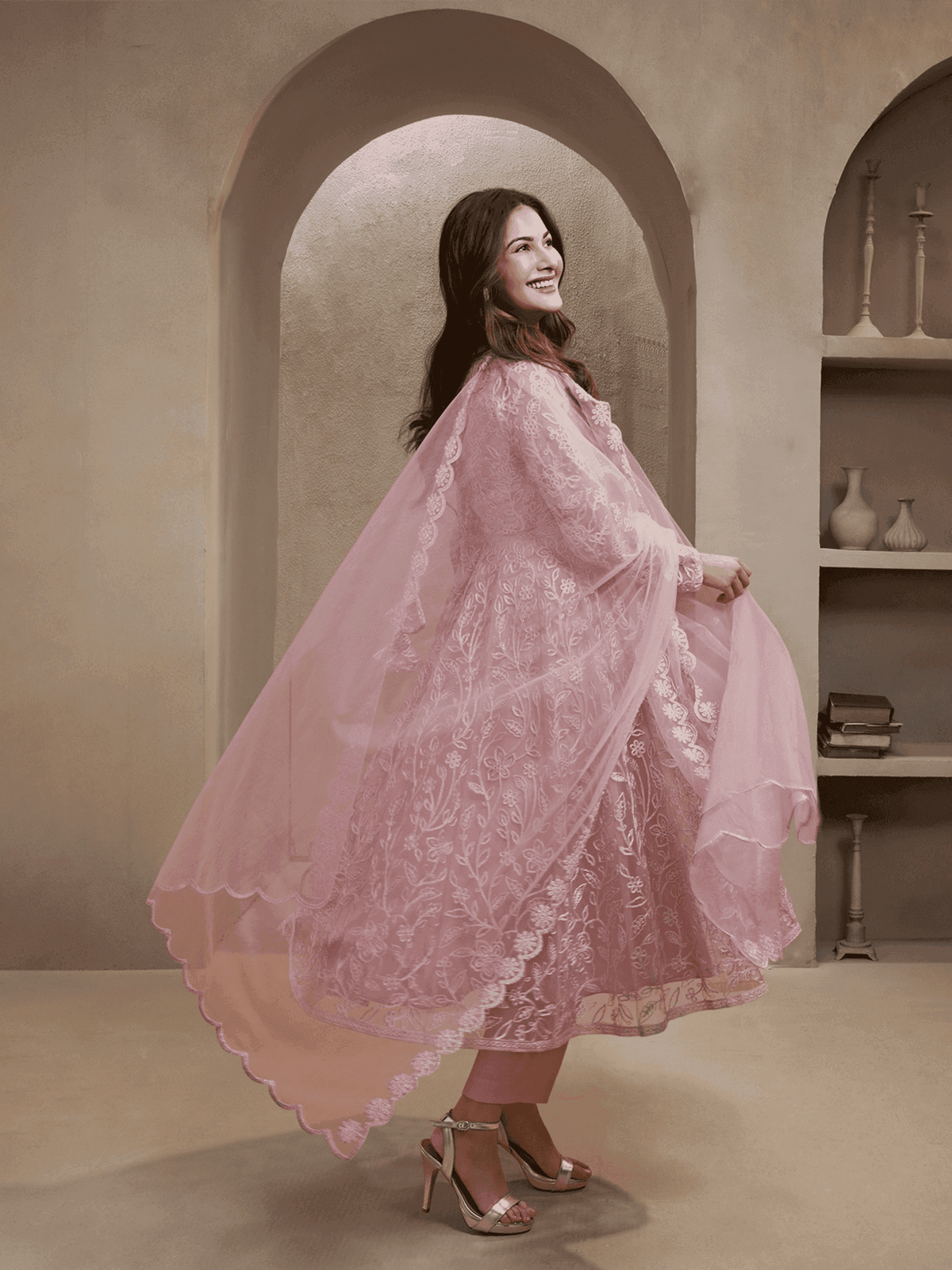 Elegant women's Zari embroidery kurta set in soft pink fabric with a flowing dupatta and stylish heels