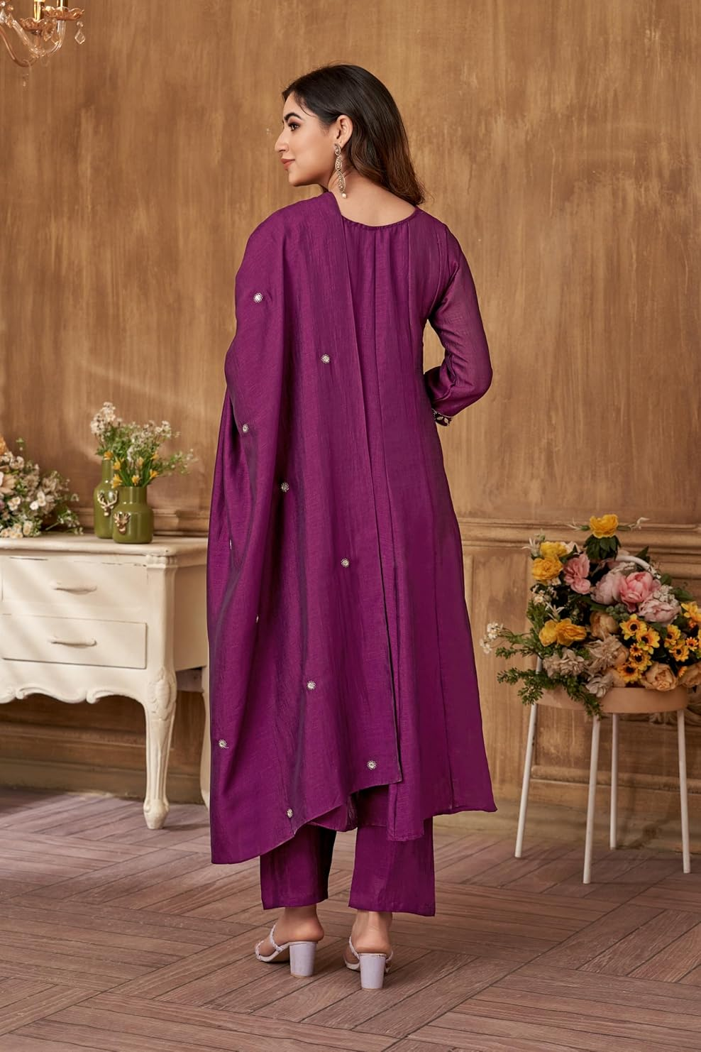 Back view of a women's Zari embroidery kurta set in purple with decorative embellishments