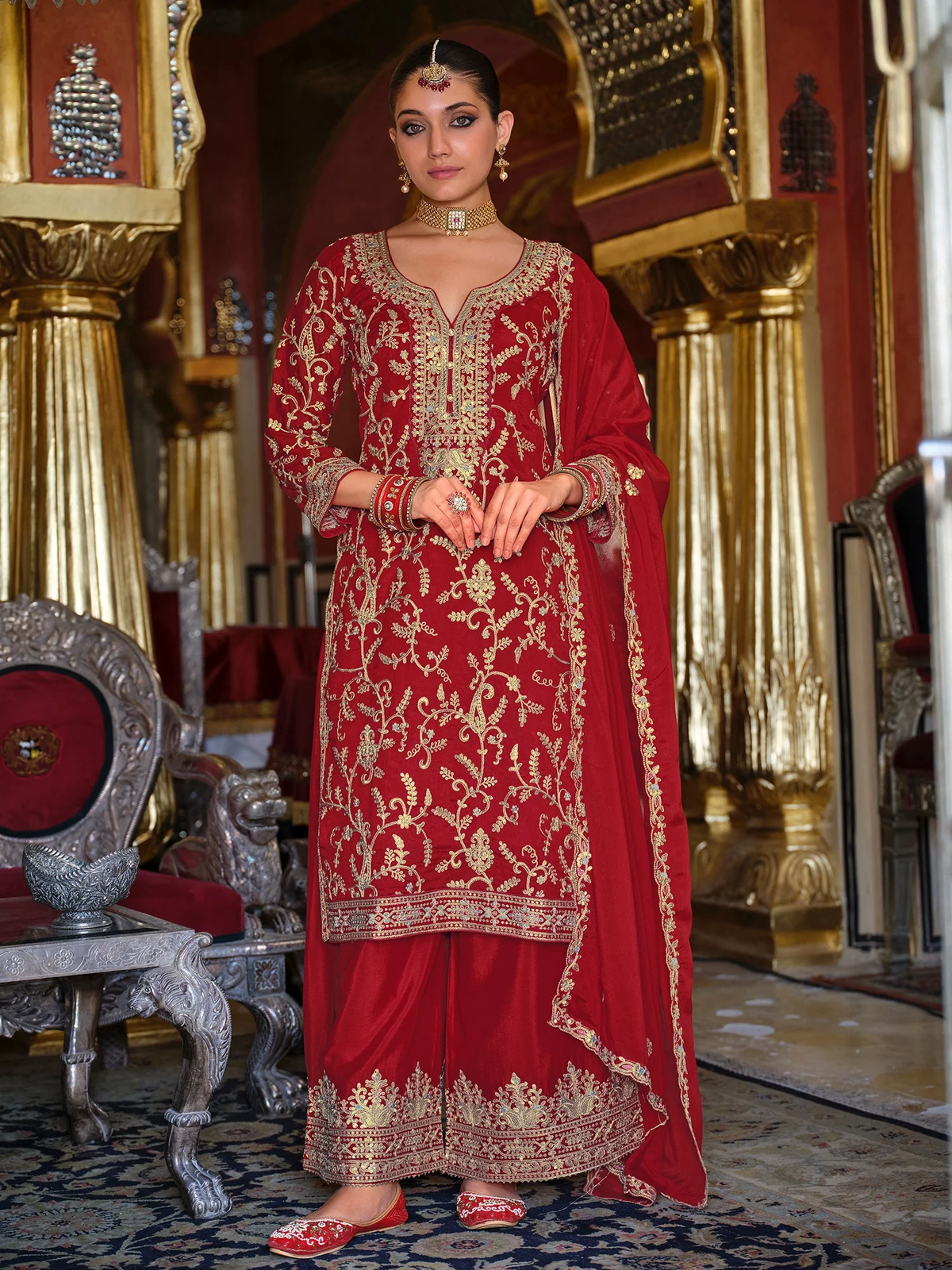 Front view of a red Zari embroidery kurta set featuring intricate gold detailing, perfect for festive occasions.